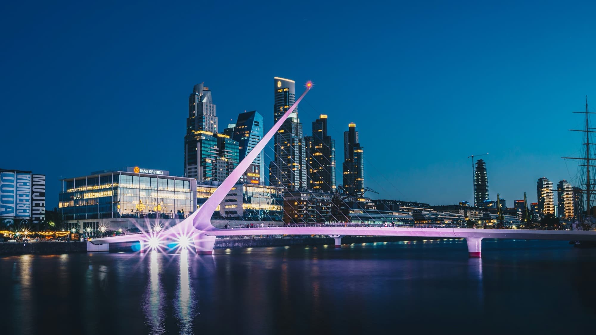Puente de la Mujer lit at night in Puerto Madero